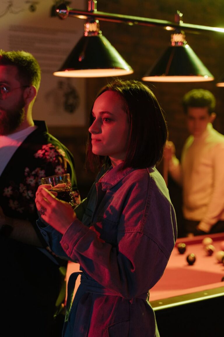 woman standing having a drink at a nightclub